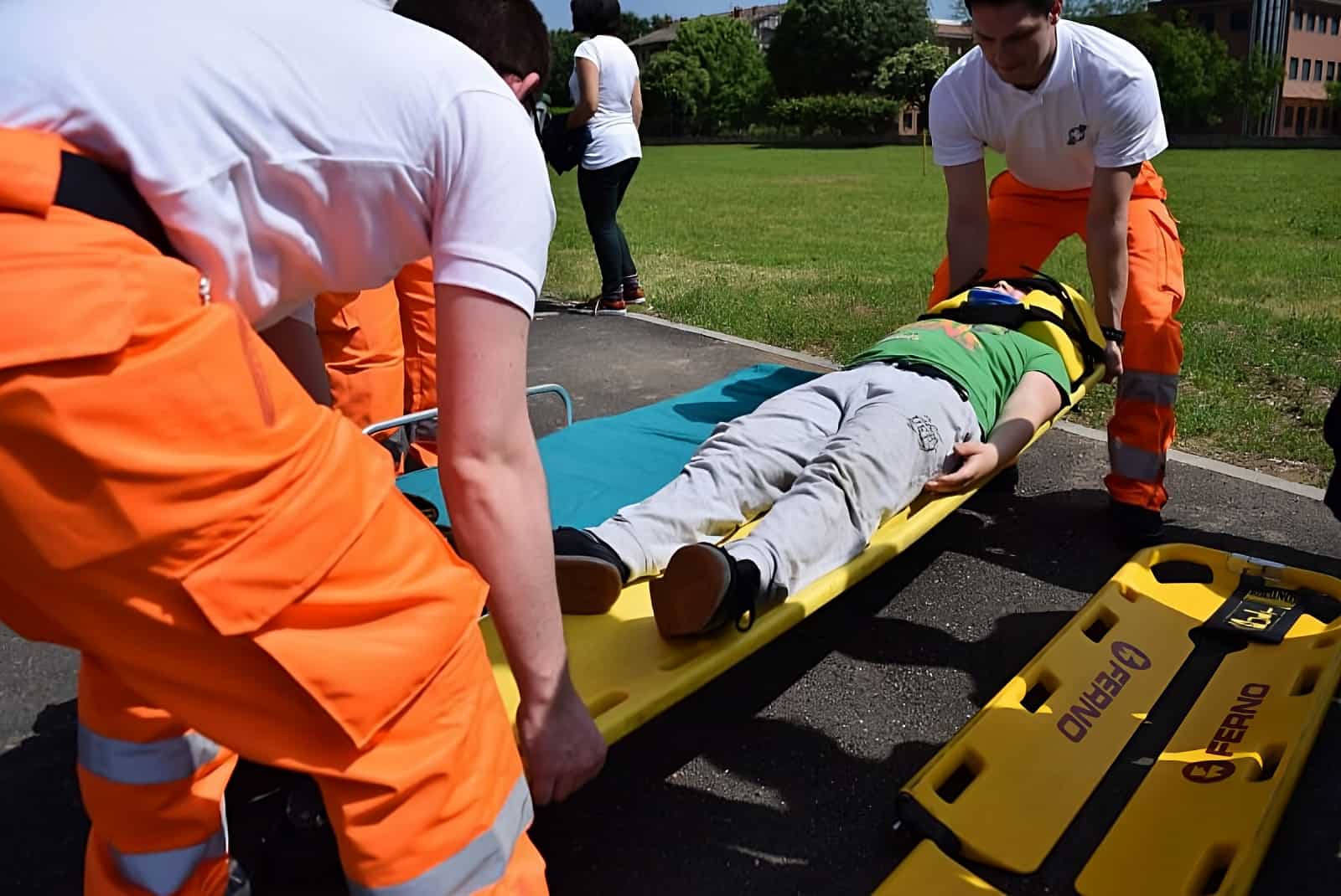 image of EMT personals picking up a person in a scratcher