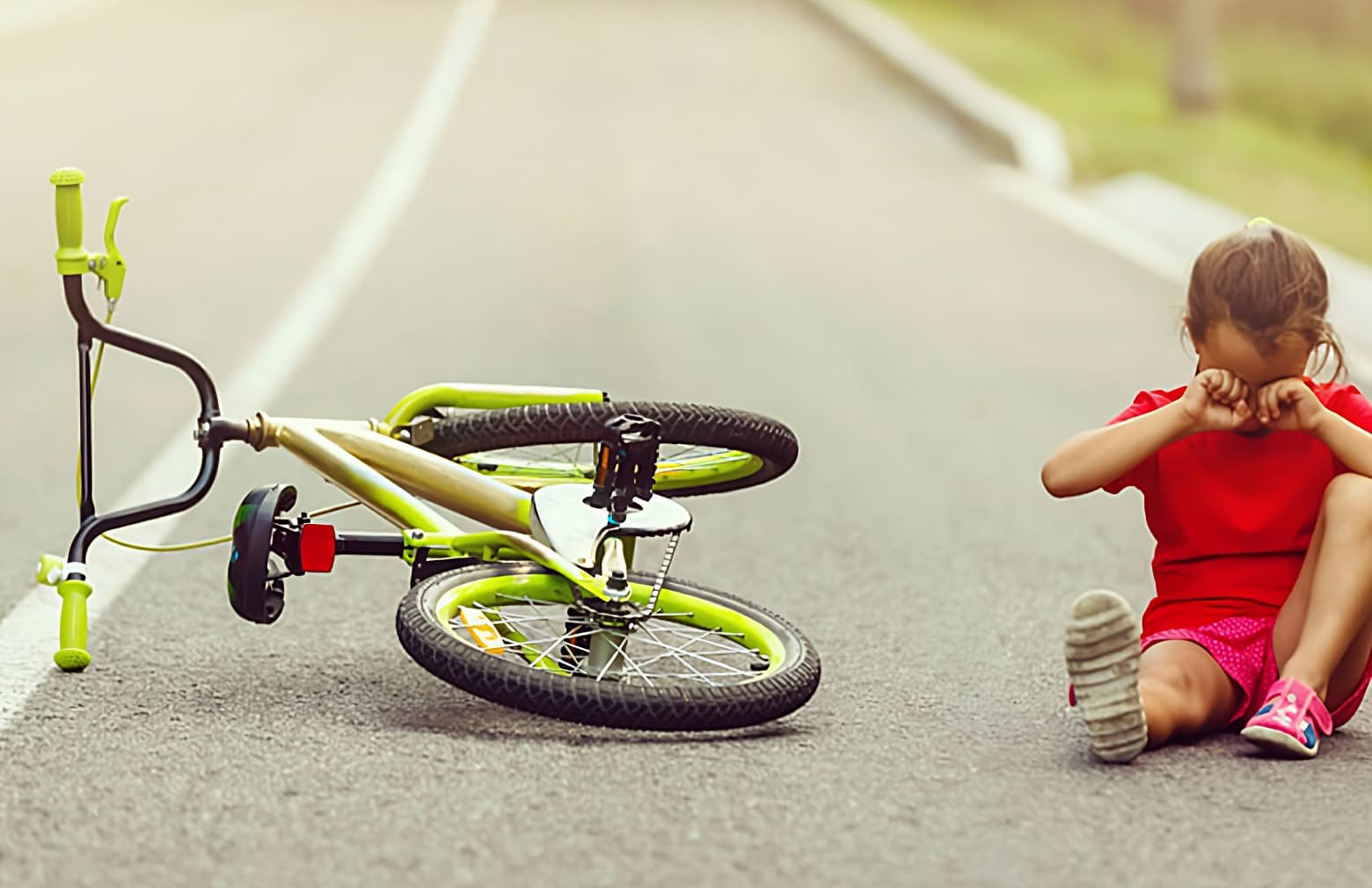 image of girl fell from bike and crying on the road